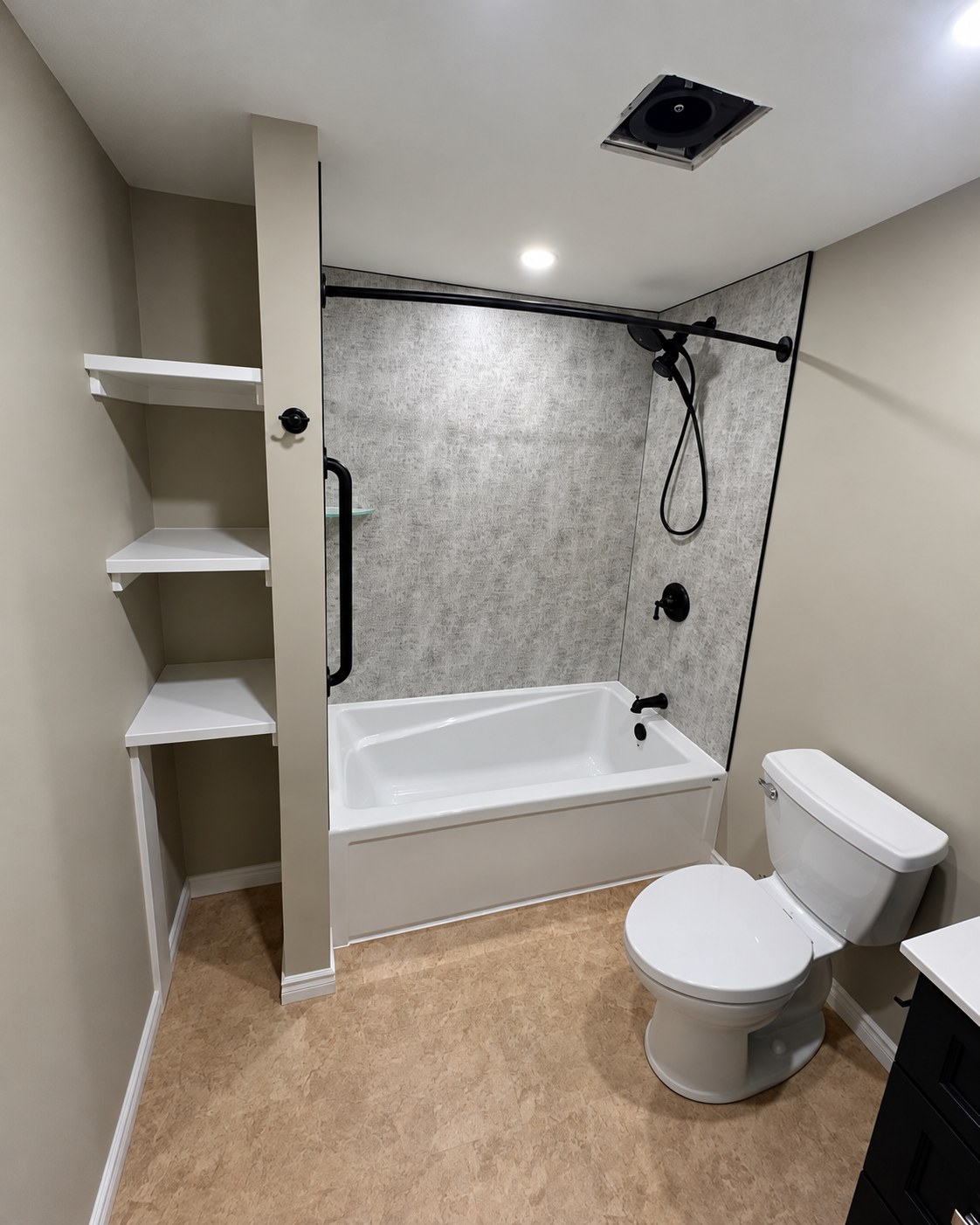 Bathtub, toilet and built-in open shelving.