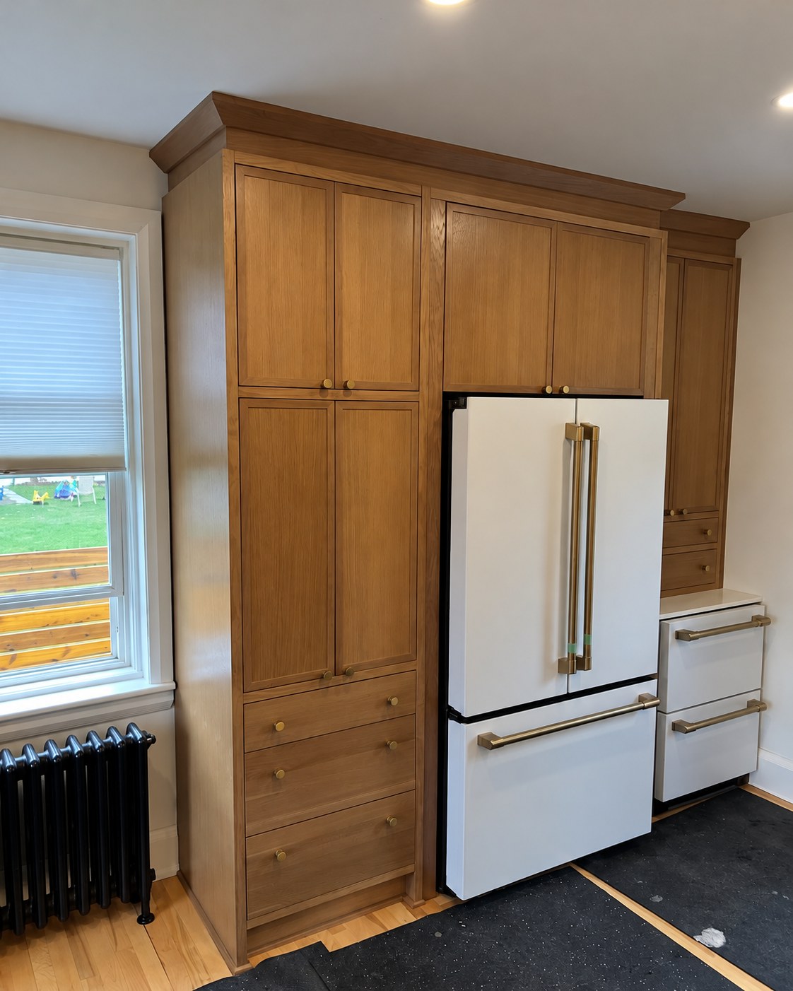 Full-height wood cabinetry surrounding the refrigerator.
