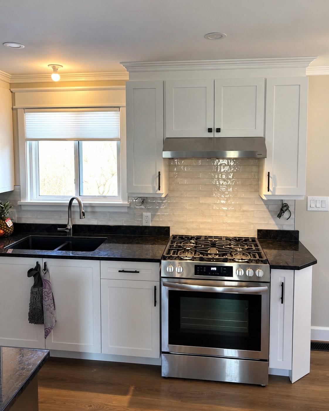 White cabinetry, dark counters and stainless-steel appliances.