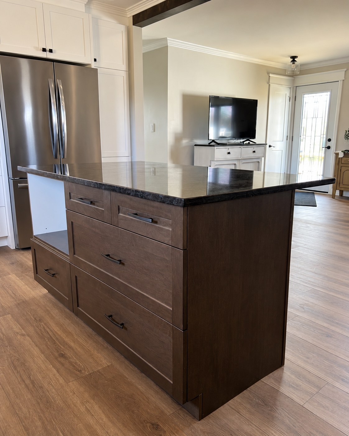Wood island with drawers and a dark countertop.