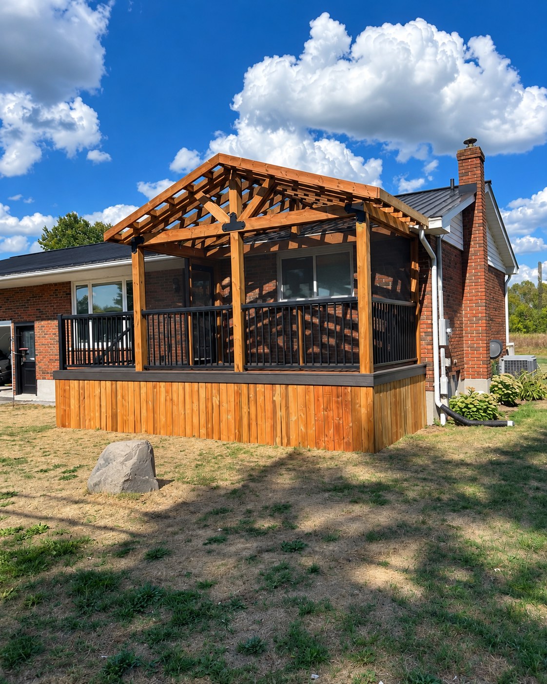 Timber-framed screened sitting area above a wood-clad deck.